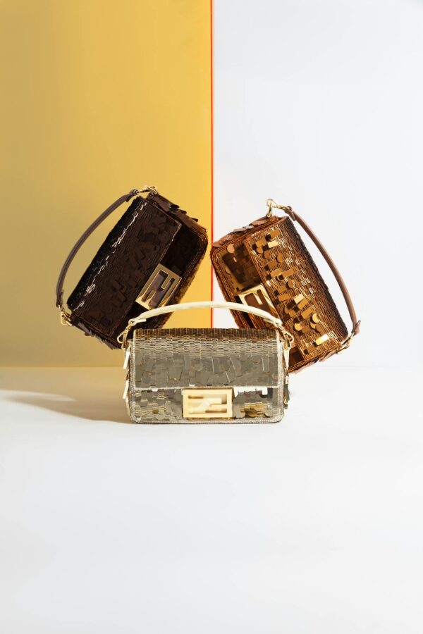 Three stylish handbags in a geometric reflective setup with a vibrant backdrop.